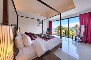 Bedroom with 1 four-poster king bed, TV, and private balcony.