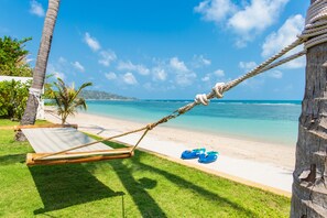 Beachfront courtyard garden with hammock and stunning sea view