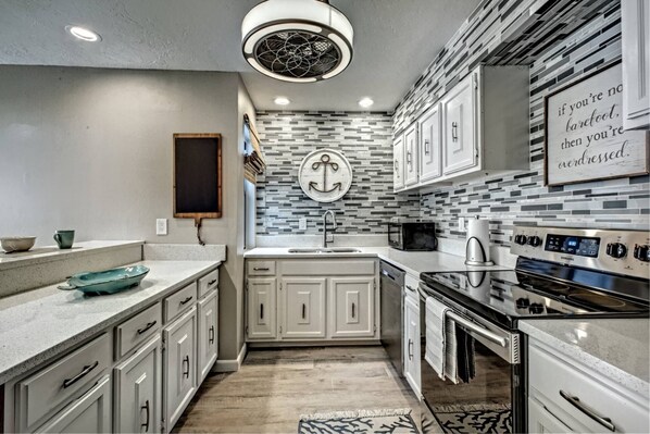 Plenty of room in the updated kitchen.  New floors, new stainless appliances and natural stone counters.