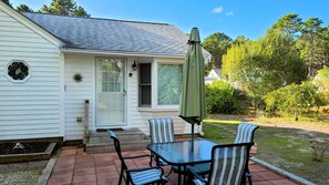 Patio with dining table and gas grill