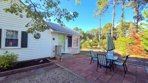 Patio with dining table and gas grill