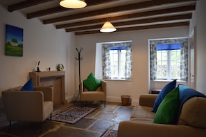 Sitting room with open fire and underfloor heating