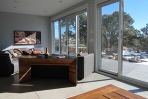 Ceiling to floor sliding glass doors line the living room.