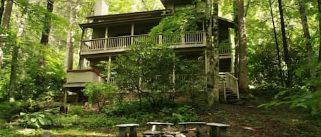 Porches, hot tub, and fire circle from creek below