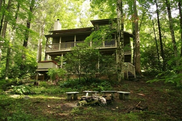 Porches, hot tub, and fire circle from creek below