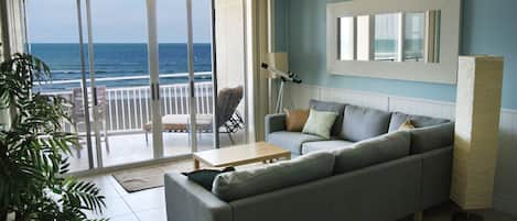 Open concept living room with beach and ocean view.