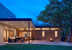 Backyard - covered patio, couches, island, gas fire pit