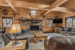 Living room featuring ample seating, 50 inch roku tv and gas fireplace