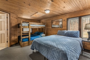 Large upstairs loft features queen size bed and full over full bunks.