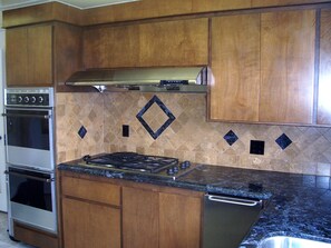 Kitchen Stove and granite counters.