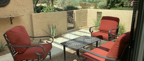 Outdoor patio view with comfy furniture.