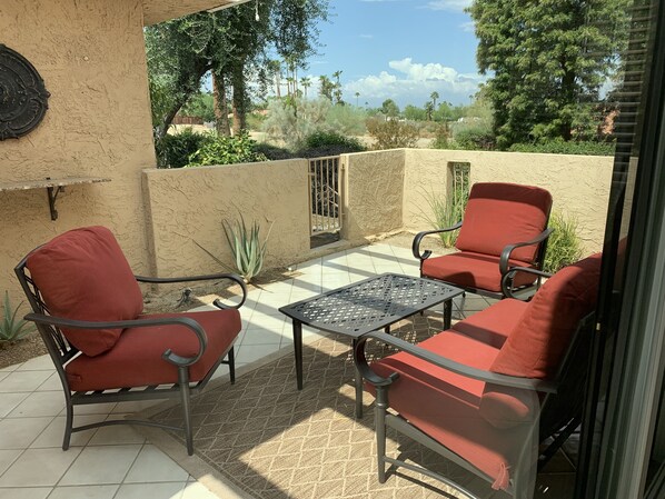Outdoor patio view with comfy furniture.