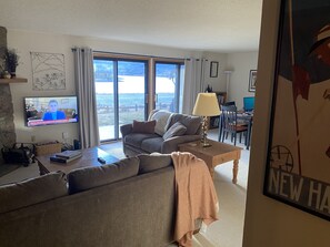 Living room with lake, mountain views.
