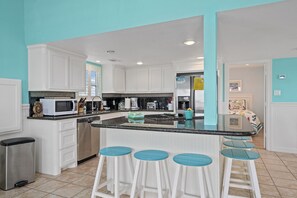 Great fully stocked kitchen with nice bar top for extra seating. 