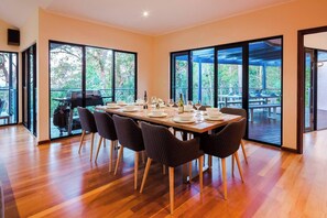 Share memorable meals at the oversized dining table with seating for ten, where good food and great company come together against a stunning bushland backdrop.