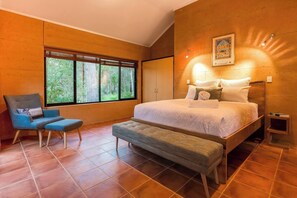 Retreat to the primary suite, featuring a queen bed, built-in wardrobe, and a private study nook for productivity. 