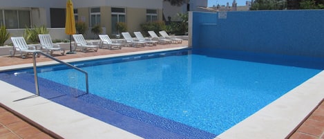 Pool with sunbeds and parasols