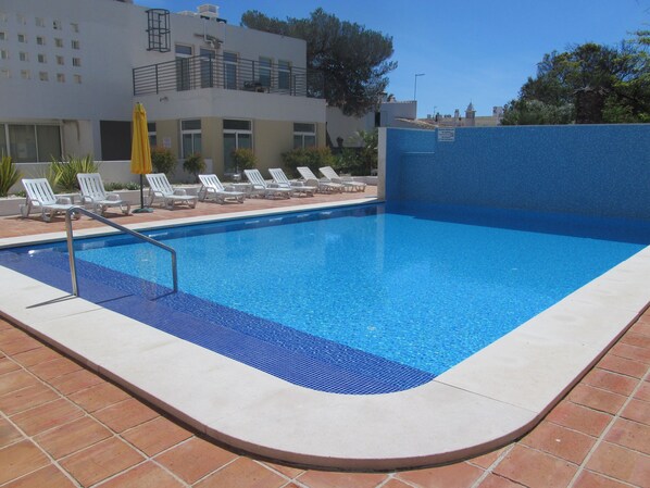 Pool with sunbeds and parasols