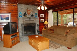 Living room with TV and wood fireplace (wood provided in season) and double HB