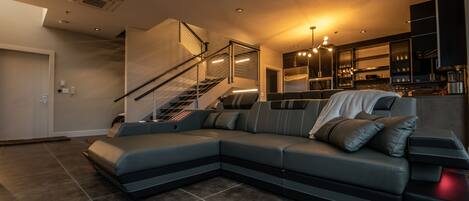 The lounge space features a custom couch, 3-sided fireplace, and great views!