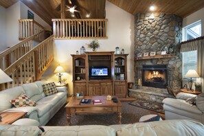 Living room with rock fireplace (firewood provided in season)