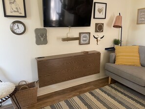 Recent upgrade under TV. Replaced free-standing desk shown in other photo.