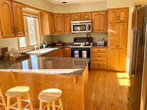 Cook, snack, and socialize in the spacious, well-lit kitchen.