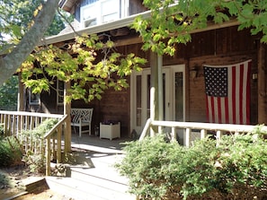 front door on expansive wraparound covered porch