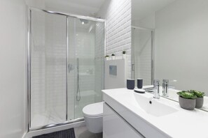 The bathroom is equipped with towels, shampoo and hair dryer.