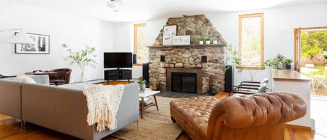 Living room with fireplace and entrance to huge deck