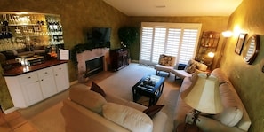 Living room w/sofa, love seat, bar area, Bose CD/Radio, & slider door to balcony