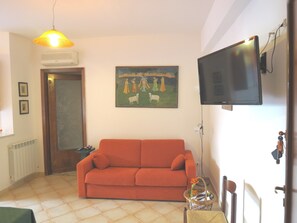 living room with sofa bed queen size for 2 and big TV