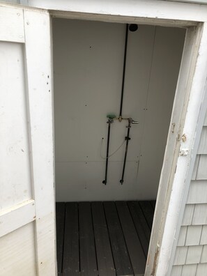 Outdoor shower located on the side of the house.  Completely enclosed.