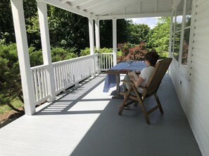 Front porch. Wonderful for reading, watching the birds, having a meal.