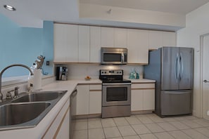 A Spacious Kitchen with New Stainless Appliances To Enhance Meals At Home