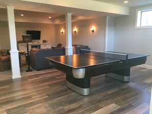 Ping pong table covers a newly resurfaced pool table. Supplies for both games 