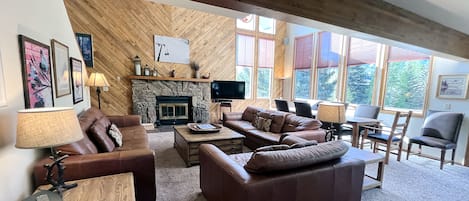 Living room with wood fireplace and dining table