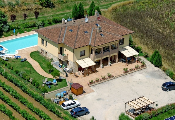 Aerial view showing large size of villa, large pool & huge parking area