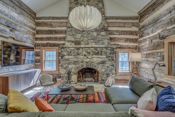 Enjoy the wood burning fireplace, flat screen tv, & cozy couch