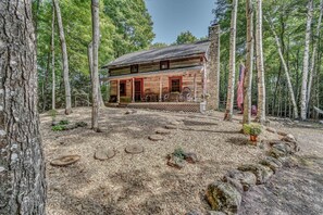 Enjoy your coffee with a view of the woods from the front porch