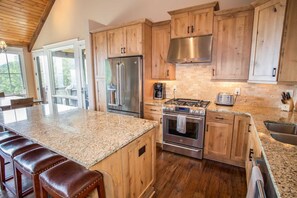 Open Kitchen with Custom Shaker-style Cabinetry and Stainless Appliances with Gas Cooktop