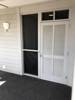 Front entrance. Laundry room inside left. Condo entrance inside right.
