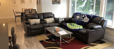 A reclining sofa and love seat provide a comfortable space for relaxation