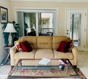 View of couch with doors to enclosed front lanai.