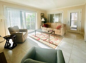 Living Room photo showing sliding door to front lanai and side lanai.