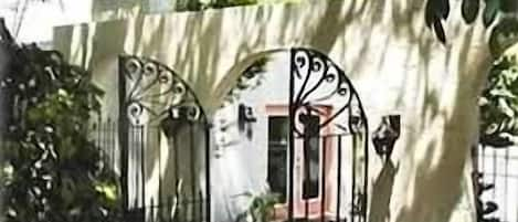 Enter the Spanish-style courtyard through the original wrought iron gates