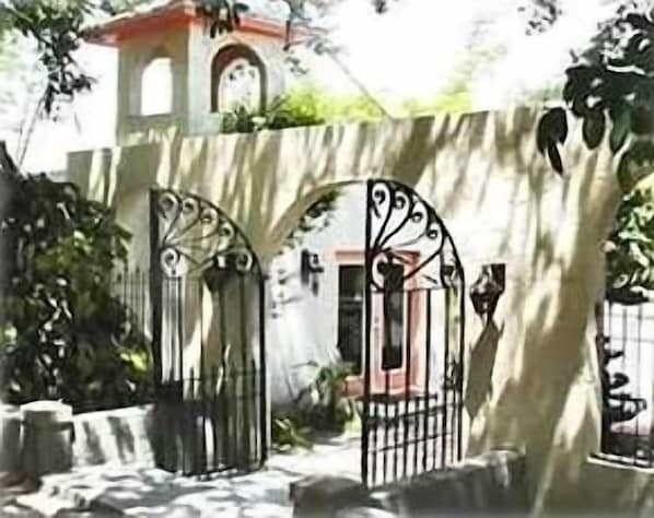 Enter the Spanish-style courtyard through the original wrought iron gates