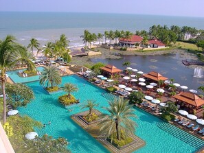 Large pool with kids' pool at the end, snack bar  and beach-side restaurant