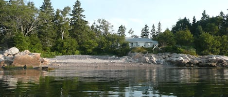 View of the house and west side beach in front on a kayak at high tide