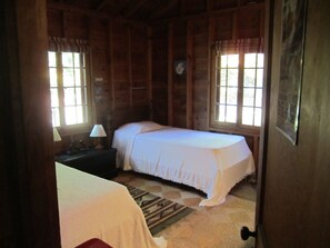 The back bedroom, with views of the woods.